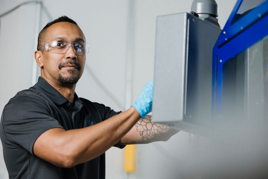 An Ultra Optics technician works on the 54R machine